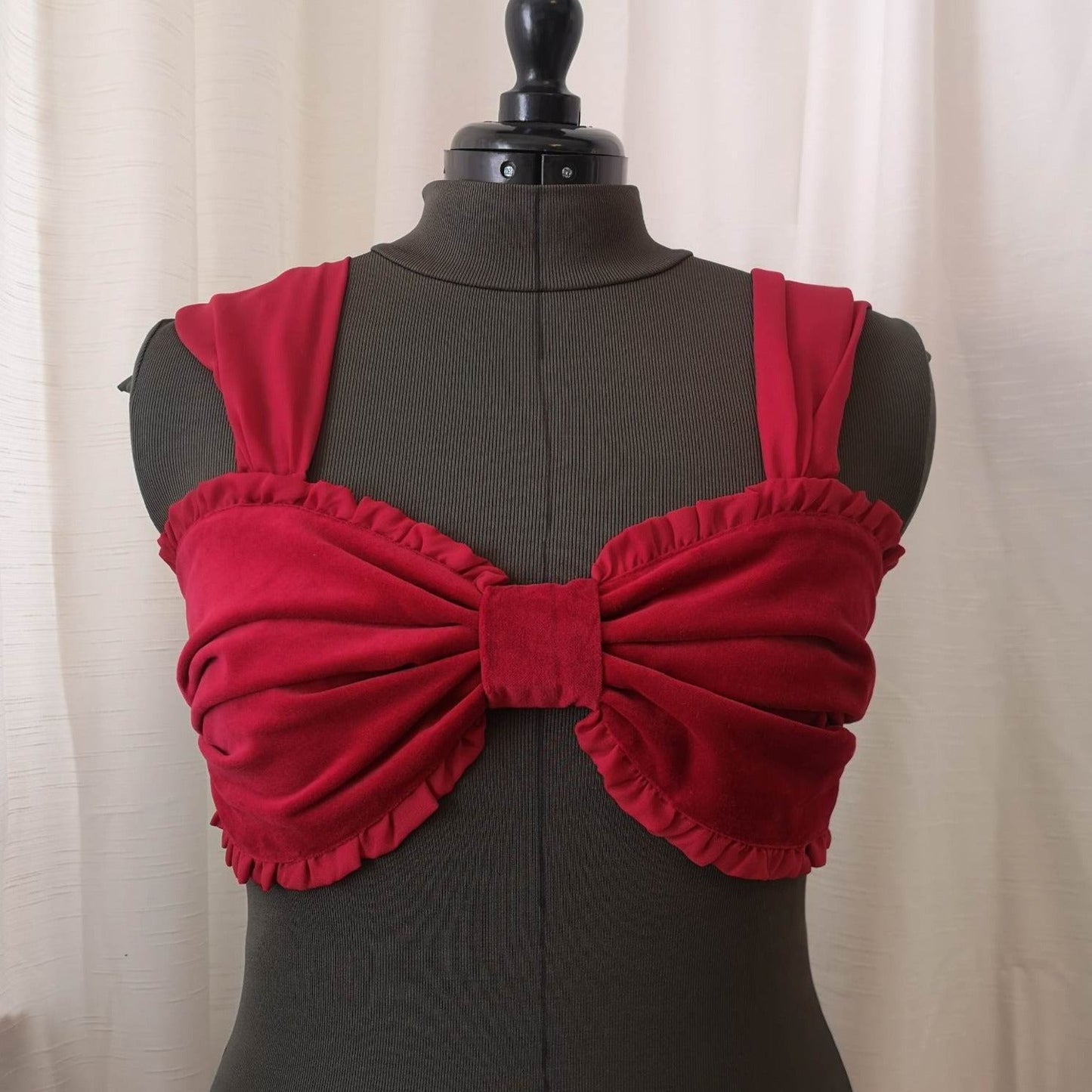 Front view of red velvet bow top shown with out sash ties.